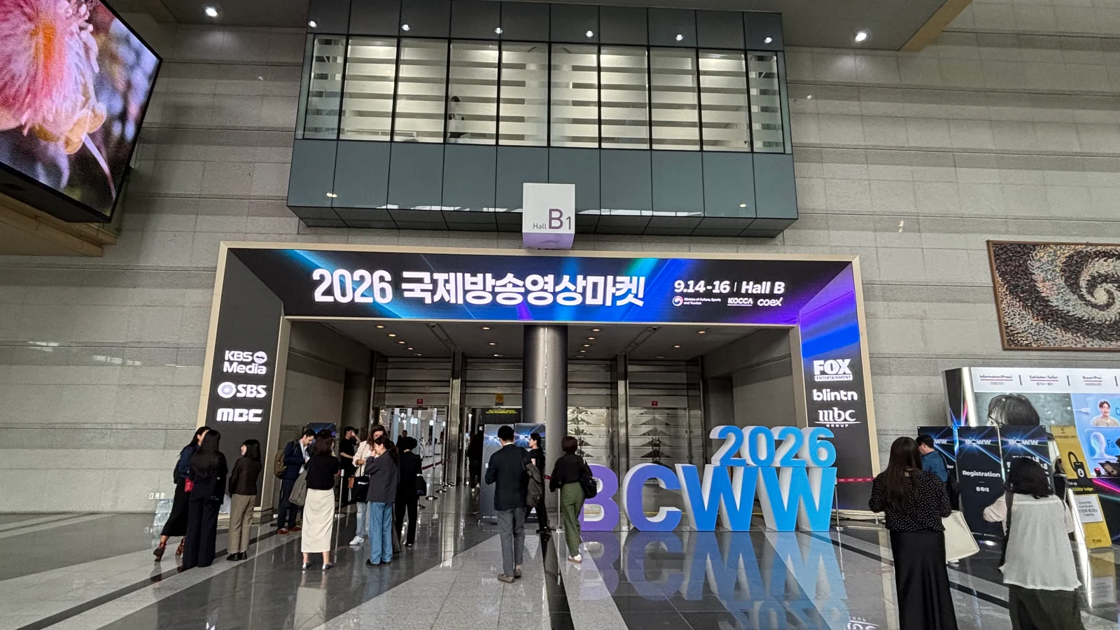 BCWW 2026 entrance at COEX Hall B in Seoul with event signage and attendees on the exhibition floor.